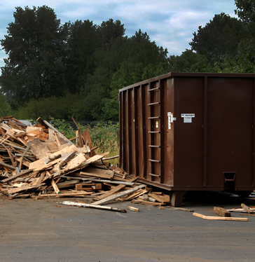 Picture of Hudson Garbage roll off container on a construction site.