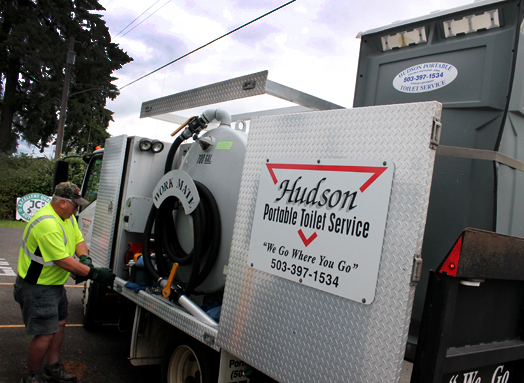 Portable toilet service truck and driver.