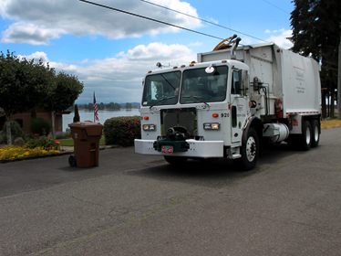 Hudson garbage truck picking up residential recycling. 